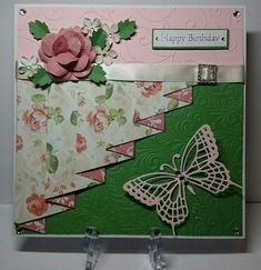 a close up of a birthday card with a pink flower and butterfly on the front