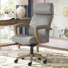 a gray office chair sitting on top of a rug