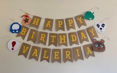 a happy birthday banner hanging on the wall with animals and other things around it that says happy birthday valeria