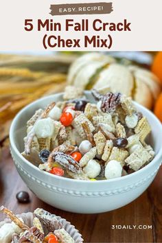 a white bowl filled with candy corn mix next to an orange and black striped pumpkin