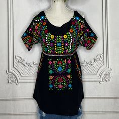 a black top with colorful flowers on it