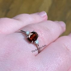 "Most Welcome to \"TheJewelryArts\" Products Description Center Stone: Genuine Garnet Center Stone Size: 6x8mm Stone Shape: Oval Cut Side Stone : Cubic Zircon Stone Clarity: VVS Material: 92.5 Sterling Silver, also available in 24k Rose Gold Vermeil/Gold Vermeil/Black Vermeil Stamp: 92.5 ➽OCCASION: Surprise your loved one with this beautiful engagement/wedding jewelry by TheJewelryArts . A classic piece of jewelry for all men/women in your life, this is a perfect gift for any occasion such as birthdays, anniversaries, wedding, engagements, Valentine's Day or Christmas day mother's day. ✔Comfort Fit ✔Nickel Free ✔Free Engraving ✔ Free Shipping ✔  Ready to Ship in 3 Business Day Customization is always welcome and please feel free to contact with me if you have any design ideas! If you have Wedding Rings Oval Cut, Garnet Wedding Rings, Rings Oval, January Birthstone Rings, Red Garnet Ring, Birthstone Rings, Gemstone Art, January Birthstone, Deco Ring