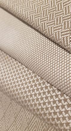 close up view of the textured fabric on a bedding set with white and beige patterns