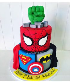 a birthday cake with a spiderman theme on it