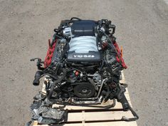 a car engine sitting on top of a wooden pallet