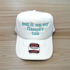 "Put it on my fiancé's tab" embroidered on your favorite color Otto Foam High-Profile Trucker Hat. How to Order: 1. Choose the color hat  2. Pick the color of thread   The saying can be customized. Message us before ordering with your request or any questions. Hat Description:  The Traditional Look 5-panel cap Seamless Foam Front Panel with Lining Matching Color Braid Visor Matching Fabric Undervisor, Adjustable Snapback SHAPE: High-Profile FABRIC:  100% Polyester Front,  Mesh Back VISOR: Pre-cu Accessories Bride, Bride Hat, Funny Hats, Hat Custom, Gifts For Fiance, Custom Hats, Summer Accessories, Terry Cloth, Trucker Cap