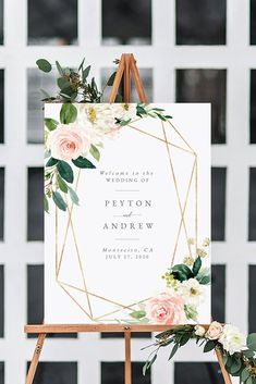 an easel with flowers and greenery on it is holding a wedding sign that says welcome to the couple