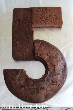 a chocolate cake that has the number five made out of it's icing