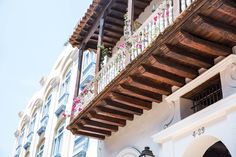 a building with flowers on the balconies