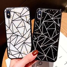 two black and white iphone cases sitting next to each other on top of a table