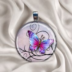 a purple butterfly sitting on top of a white cloth covered table next to a silver chain