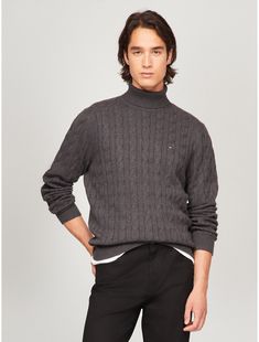 Tommy Hilfiger men's sweater. Made from soft cotton in a textured cable knit weave, this turtleneck sweater is the perfect layer, complete with rib-knit cuffs, collar and hem with touches of subtle branding throughout.  Material: 100% Cotton. Cable Knit Turtleneck, Cable Knit Turtleneck Sweater, Knit Turtleneck, Knit Turtleneck Sweater, Pants Large, Tommy Hilfiger Man, Knit Cuff, Men's Sweater, Fitted Hats