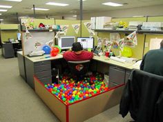 an office cubicle filled with lots of toys and desks covered in legos