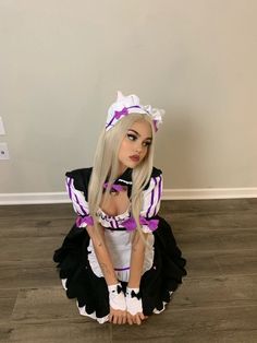 a doll is sitting on the floor wearing a costume