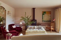 a living room filled with furniture and a fire place next to a painting on the wall