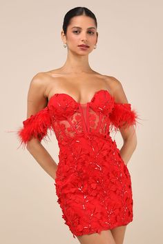 a woman wearing a red dress with feathers on it