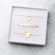 "A beautifully understated stacking bracelet set, featuring delicate, minimal shapes that can be personalised with a special message or date. Available in 14k gold fill and sterling silver. This set includes: + Skinny bar bracelet- max 25 characters. + Diamond tag bracelet - single character. + Hammered disc bracelet - single character. Each bracelet has a 1\" length of extender chain attached so that you can adjust the size for a perfect fit. So for example, if you choose the 6.5\" size, it wil Minimalist Stackable Jewelry For Personalized Gifts, Minimalist Silver Name Bracelet For Bridesmaids, Minimalist Sterling Silver Name Bracelet For Personalized Gift, Minimalist Sterling Silver Name Bracelet As Personalized Gift, Minimalist Rose Gold Name Bracelet With Initials, Minimalist Rose Gold Initials Name Bracelet, Minimalist Custom Name Bracelet, Personalized Minimalist Name Bracelet For Bridesmaid, Minimalist Personalized Name Bracelet For Bridesmaid