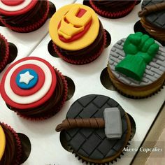 the cupcakes are decorated with captain america and iron man symbols on top of them