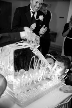 a couple of people that are standing in front of a cake