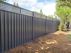 a black metal fence in the middle of a yard