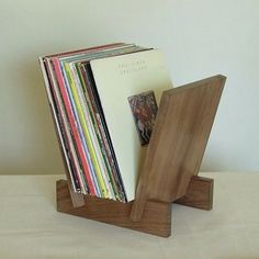 a stack of records sitting on top of a wooden stand