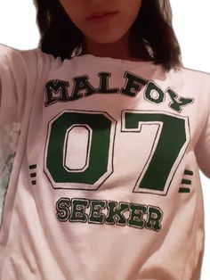 a girl wearing a shirt that says malfoy 07 and has the number seven on it