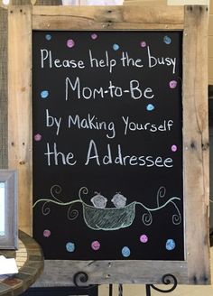 a chalkboard sign that says please help the busy mom - to - be by making yourself the adressee