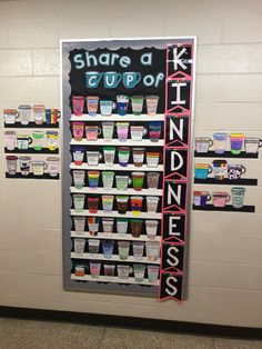 a sign that says share a cup of kindness on the side of a wall in a classroom