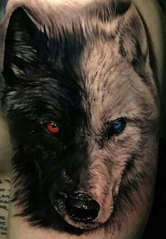 a man's leg with a wolf tattoo on it and red eyes in the center