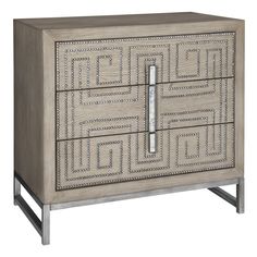 a wooden cabinet with two drawers and an intricate design on the front, along with metal legs