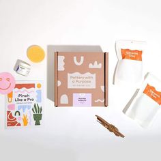 the contents of a craft kit including paper, scissors and other items are laid out on a white surface