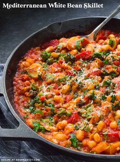 a skillet filled with pasta and vegetables