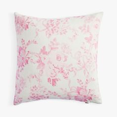 a pink and white pillow with flowers on it