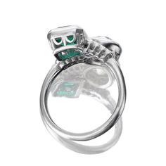 Toi et Moi Engagement Ring with Old European Cut Diamond and Colombian Emerald The Evora ring is a remake of an authentic vintage diamond and emerald ring from the Art Deco Era circa 1920. The ring features a GIA-certified 1.46-carat Old European Cut diamond of I color, I1 clarity and a GCS-certified 1.12-carat Octagonal Cut Colombian emerald of minor clarity enhancement. On either side of the center stones are eight Old European Cut diamonds of approximately H-I color, totaling approximately 0.16 carats. The stones are set in a platinum setting. The ring is currently size 6 and can be resized! Why We Love It This ring was originally an antique piece but the ring itself wasn't sturdy enough for daily wear. So, we took the stones out and remade the ring with the same stones and same design Art Deco Emerald Ring With 17 Jewels, Luxury Hallmarked Round Cut Emerald Ring, Formal Hallmarked Platinum Emerald Ring, Hallmarked Platinum Emerald Ring For Formal Occasions, Classic Platinum Emerald Ring With Round Cut, Platinum Oval Emerald Ring With 17 Jewels, Classic Round Cut Emerald Ring In Platinum, Oval Platinum Emerald Ring With 17 Jewels, Luxury Emerald Rings Hallmarked