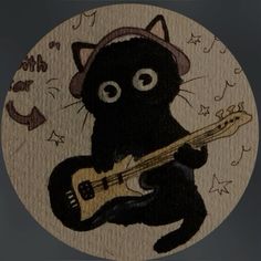 a black cat with a hat playing a guitar