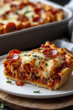 a slice of lasagna on a white plate next to a casserole dish