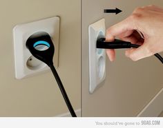 a person is plugging an outlet in the wall with a black and white cord