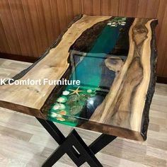 a table made out of wood with an aquarium in the center and starfish on top