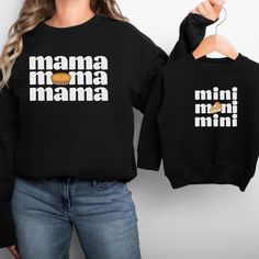 These adorable Thanksgiving matching mommy and me sweatshirts are perfect for the entire family! Available in multiple sizes and shirt styles to fit toddlers, babies, and of course mom! The sweatshirts, t-shirts, and baby bodysuits are all made of soft, high-quality fabric to keep everyone comfy and cozy this fall! How to Order Your Matching Shirts: 1) Select the Size from the dropdown menu. Select the shirt color. Then let me know in the personalization box if you would like either "Mama" or "Mini." Click "Add to Cart". 2) Go back to the listing, select the second size (for the second person), add the color, and tell me either "Mama" or "Mini" and click "Add to Cart" again. 3) Repeat for as many sizes as you would like.  4) Once all the desired sizes are added to your cart, proceed to che Mom And Son Thanksgiving Outfits, Casual Black Sweatshirt For Mother's Day, Family Matching Graphic Print Sweatshirt, Family Letter Print Tops For Fall, Family Matching Long Sleeve T-shirt, Fall Tops With Letter Print, Casual Winter Tops For Family Occasions, Graphic Print Long Sleeve Top, Matching Long Sleeve Tops For Mother's Day