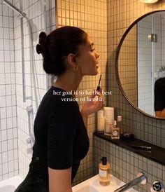 a woman brushing her teeth in front of a bathroom mirror with the caption, here goal is to be the best version of redefit