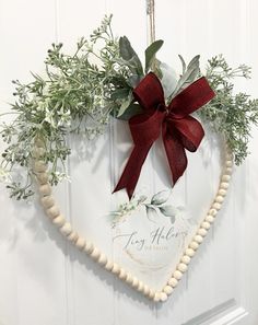 a heart shaped wreath hanging on the front door