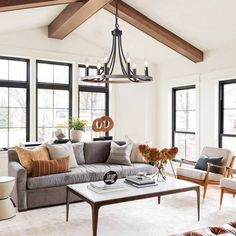 a living room filled with furniture and lots of windows