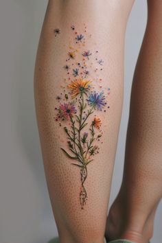 a woman's legs with flowers and butterflies on them