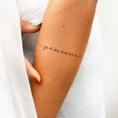 a woman's arm with the word precious written in cursive writing on it