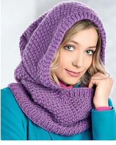 a woman wearing a purple knitted cowl with a hood on her head, posing for the camera