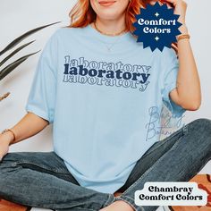 Laboratory Comfort Colors T Shirt, Long Sleeve Tee, or Sweatshirt.  Customize the text to Blood Bank, Lab Tech, Scientist, Stem Cell, Micro, Histology or whatever you like.  Perfect gift for Lab Week 2024! Get your coworker something they can wear year round!  📫 Super Fast Shipping! Most sizes and colors Ship Next Business Day! 👚T Shirt Version Here with pics https://blazingbotanicals.etsy.com/listing/1672220202 🧵 All Size Charts Here https://blazingbotanicals.etsy.com/listing/1684651987 ✨ SI Blue T-shirt With Slogan In Relaxed Fit, Blue Graphic Tee With Lettering, Blue Relaxed Fit Tops With Lettering, Blue Short Sleeve T-shirt With Lettering, Blue Short Sleeve Tops With Lettering, Medical Lab Technician, Lab Week, Medical Lab, Lab Technician