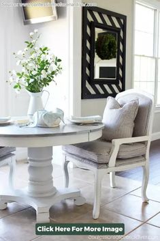 a dining room table with two chairs around it