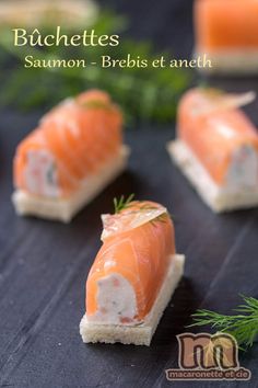 small pieces of salmon on bread with cream cheese and dill garnishes