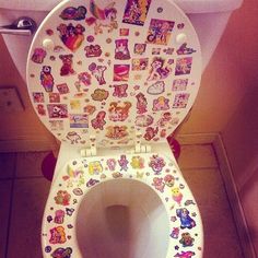 the toilet has many stickers on it