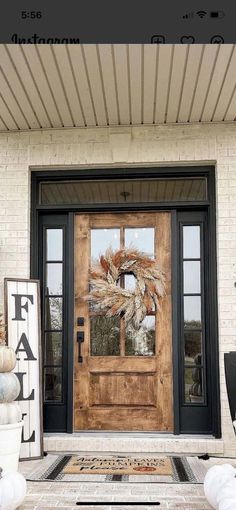 the front door is decorated with fall decorations